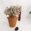Geflochtene Rattanvase im Boho-Stil Geflochtene Rattanvase im Boho-Stil