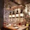 LED-Hängelampe mit Treibholz und Laternen im Industrie-Stil LED-Hängelampe mit Treibholz und Laternen im Industrie-Stil